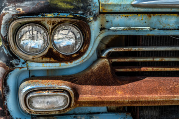 front metal grill, headlight and bumper old rusted junk pickup truck 