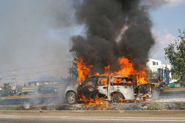 Burning car on the highway road