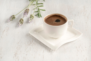 Turkish coffee on a table decorated with lavender flowers