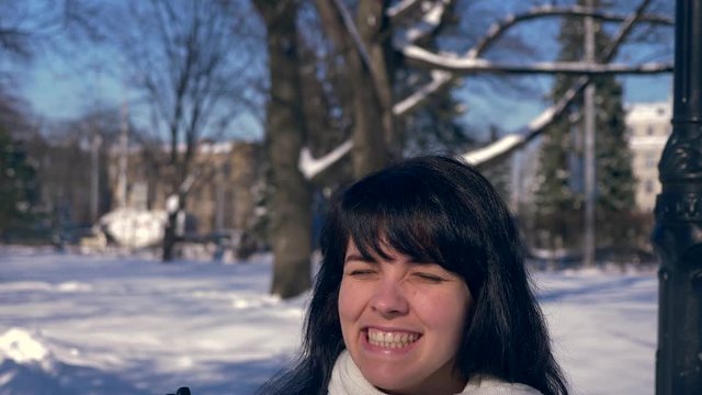 Very Happy Beautiful Girl Fists Pump Feeling Awesome Glad Emotion In Snow Covered Park. Winter City Life. Bright Sunny Day. Slow Motion 30 fps 0.5 normal speed 60 fps