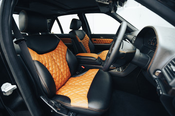 Sports car interior with black and orange leather