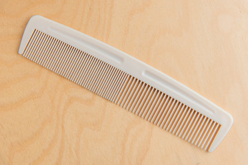 Plastic Comb On Wood Background, White Plastic Comb