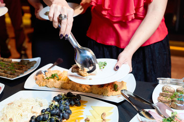 People at a banquet taking different food. Colleagues Buffet Party Brunch Dining Concept