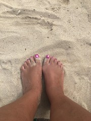 female feet on the beach