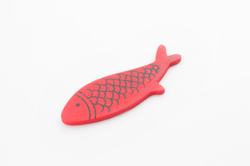 wooden red fish on white background