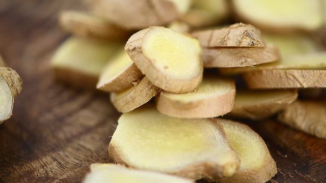 Rotating wooden plate with fresh Ginger as seamless loopable 4K footage