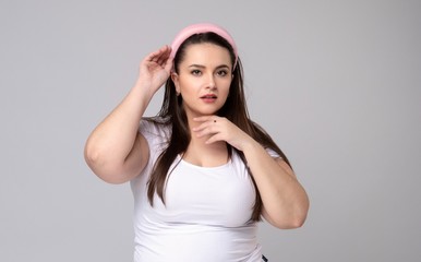 Plus size woman with hair rim in her hair.