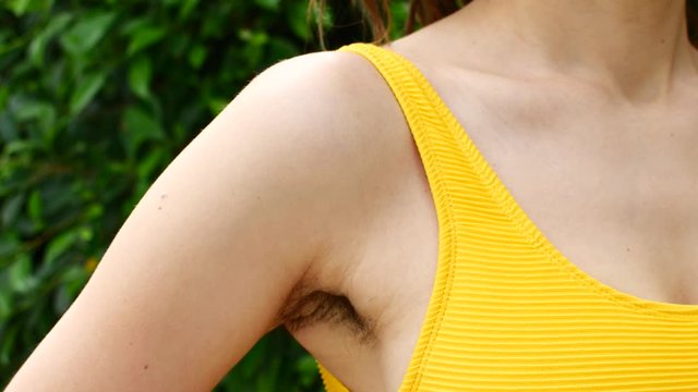 Natural woman with unshaven armpits. Woman's natural hair, feminist concept