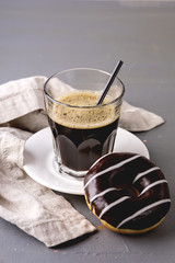Glass of Black Americano Coffee and Tasty Chocolate Donut on Gray Background Morning Breakfast Lifestyle Vertical