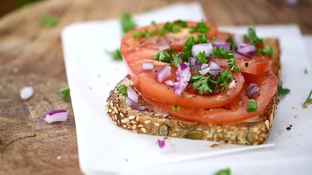 Tomato Sandwich on a rotating plate (seamless loopable close-up footage; 4K)