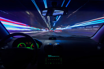 Night view from inside a car with moving lights. Speed.