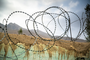 Barbed wire on the wall in Ishkashim, Afghanistan