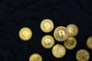 Top view of golden bitcoins on black background with copy space on left. Crypto currency concept photo.