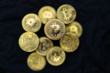 Close-up photo of golden bitcoins on black background. Crypto currency concept photo.