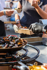 chef cooks mussels at the street food festival