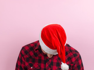 Emotions on the face, tired, holiday hangover, awareness. A man in a plaid rabbit and a Christmas...