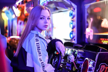 Beautiful blonde girl playing car racing on a slot machine. Girl gamer © Регина Ерофеева