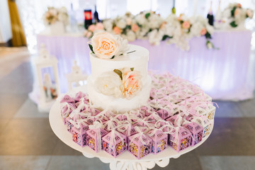 Wedding bonbonnieres, lilac openwork paper boxes at the wedding Banquet