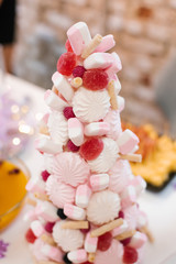 Christmas tree of marshmallows, marmalade and sweets on the buffet holiday table. Christmas menu