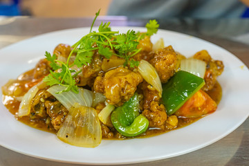 Plate of crispy sweet and sour pork ribs and vegetables