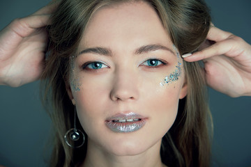 Fashion make-up. Shiny oil skin, Beautiful young woman with clean perfect skin. Close up, copyspace