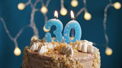 Birthday cake with 30 number candle on blue backgraund. Candles blow out. Slow motion and close-up view - Powered by Adobe