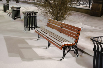 Bench at night in the Park, in winter in the snow.A lonely bench at night.