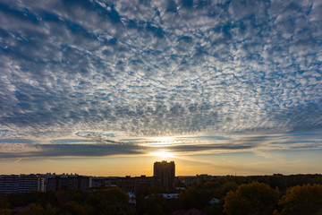 Fototapeta premium Colorful dawn over the city, beautiful clouds in the sky