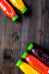 plastic bottles with fruit drinks on wooden background top view mockup