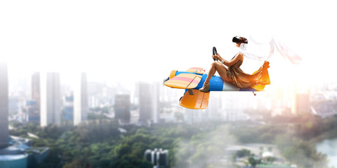 Woman in retro airplane . Mixed media