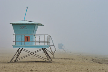 Lifeguards towers on the beach during foggy weather in Santa Cruz, CA
