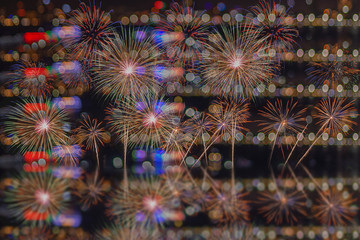 Colorful fireworks at night in a wonderful New Year's festival on photos of city blurred bokeh on celebratory nights.