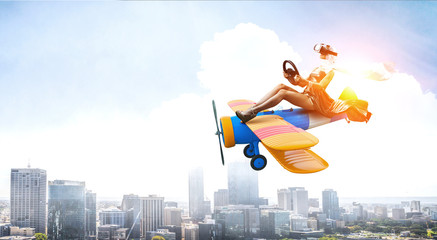 Woman in retro airplane . Mixed media