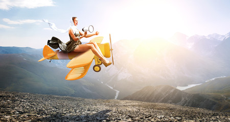 Woman in retro airplane . Mixed media