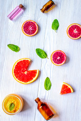 organic cosmetic with citrus on wooden background top view