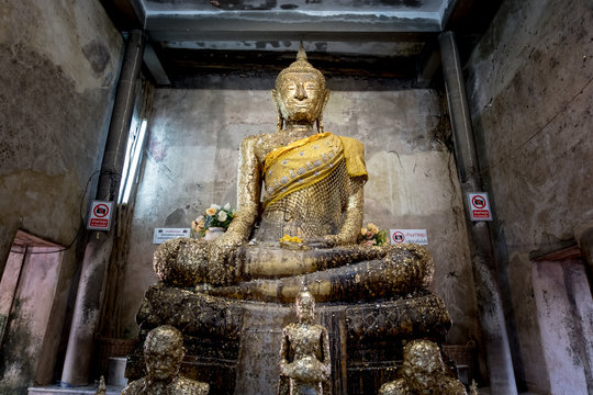 Golden antique buddha statue. Buddha image in a temple in Bangkok, Thailand.