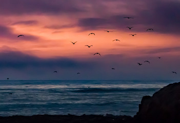 Sunset over the Pacific coast of California along the rocky shoreline in Cambria, from a lookout...