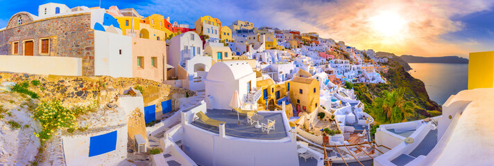 Oia town on Santorini island, Greece. Traditional and famous houses and churches with blue domes over the Caldera, Aegean sea - obrazy, fototapety, plakaty
