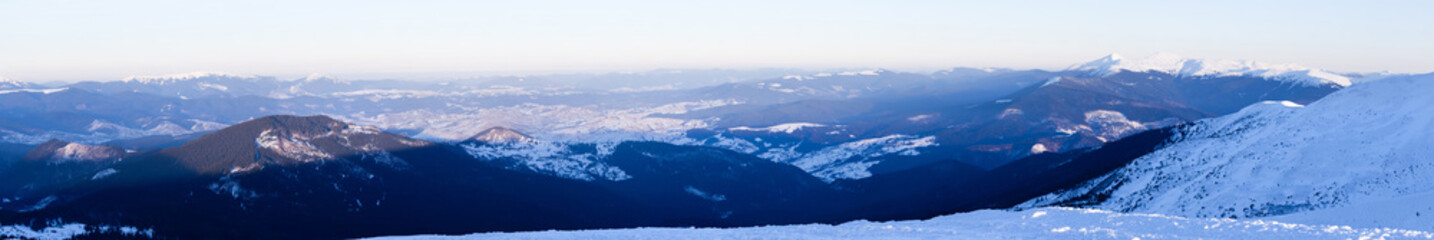 Fototapeta premium Panoramic view of winter mountain peaks covered with snow