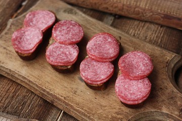 Sandwiches with bread and sausage on the table 