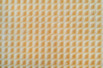 Waffles background cell texture closeup. View of tasty waffles