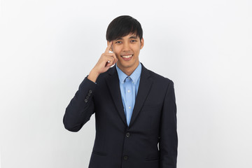 Young handsome asian business man thinking an idea while looking up isolated on white background.