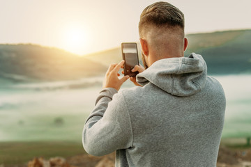Man making selfie on top of mountain