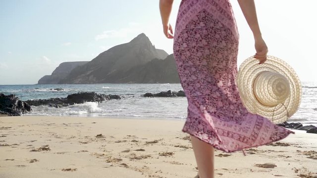 Calheta beach in Porto Santo Island - Slow-motion of a tourist girl walking towards the sea