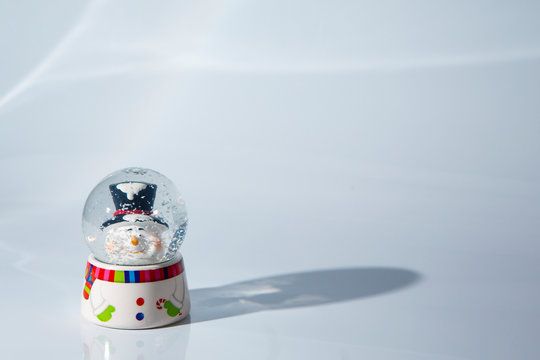 Chirstams globe with a snowman on a white background