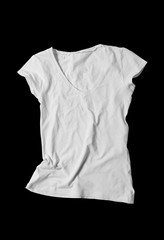 Blank white women's t-shirt on black cut background. Mock-up.