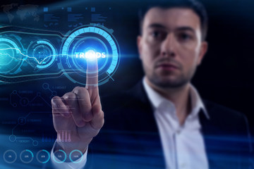 Business, Technology, Internet and network concept. Young businessman working on a virtual screen of the future and sees the inscription: Trends
