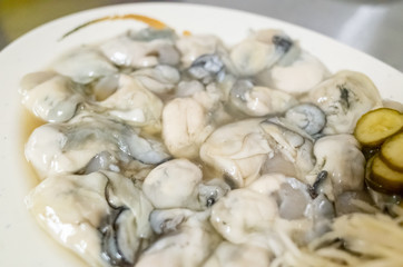 fresh oysters close-up on white plate
