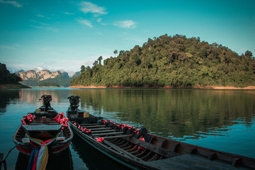 Long tail boat on lake with beautiful mountain at Khao Sok National Park, Suratthani Province, Thailand