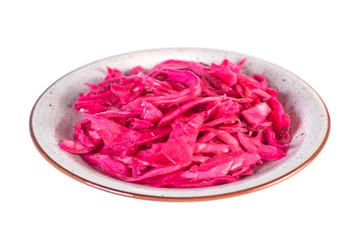 Tasty red sauerkraut or fermented cabbage in marinade on a plate isolated on white.